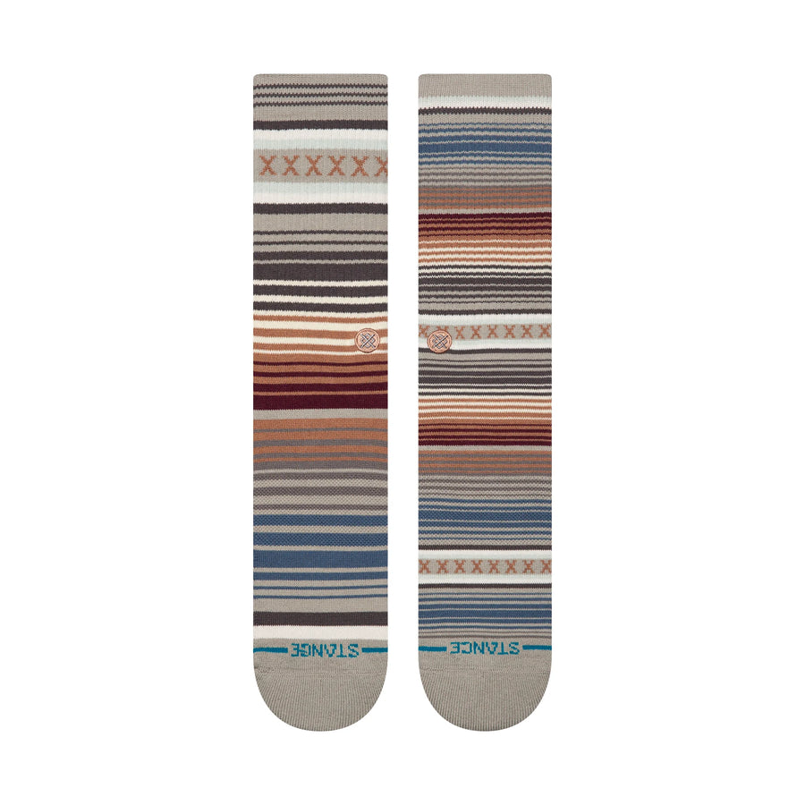 Two striped stance curren st crew socks with a pattern on a white background