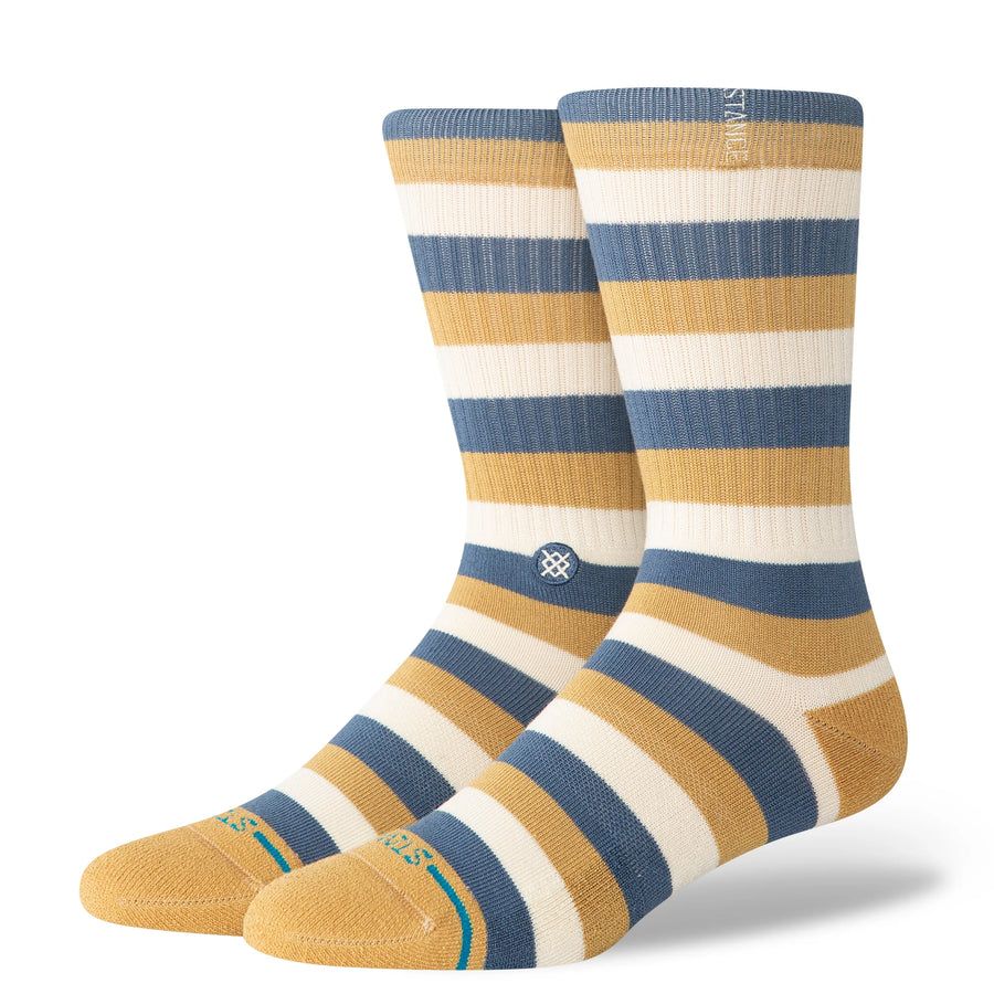 Pair of striped stance butterblend hiland socks with blue, yellow, and white colors on a white background