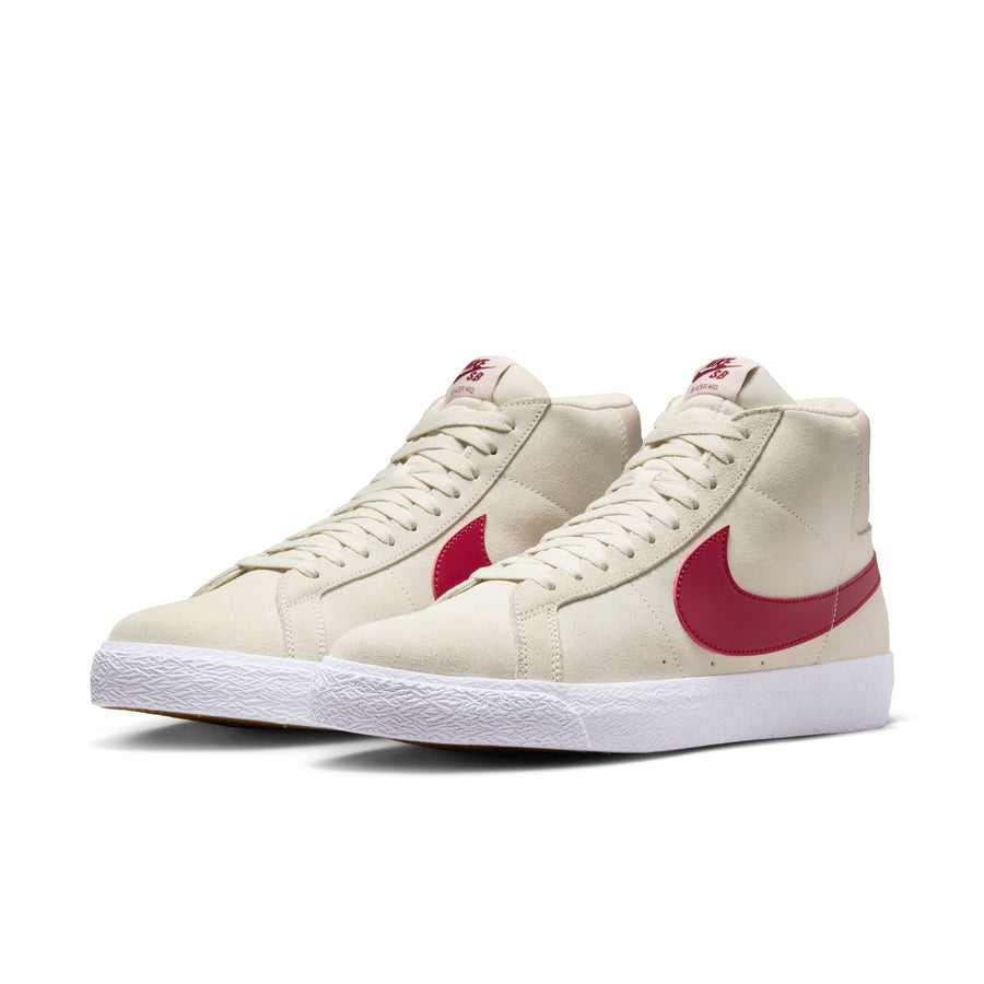 Beige nike sb blazer mid skateboard sneaker with red swoosh logo on a white background