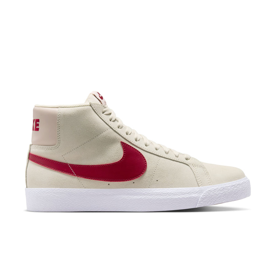 Beige nike sb blazer mid skateboard sneaker with red swoosh logo on a white background