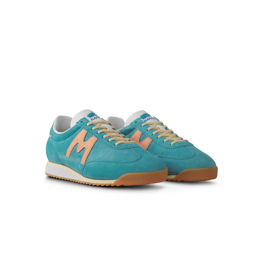blue karhu mestari women's shoe with peach orange M logo and yellow and white sole