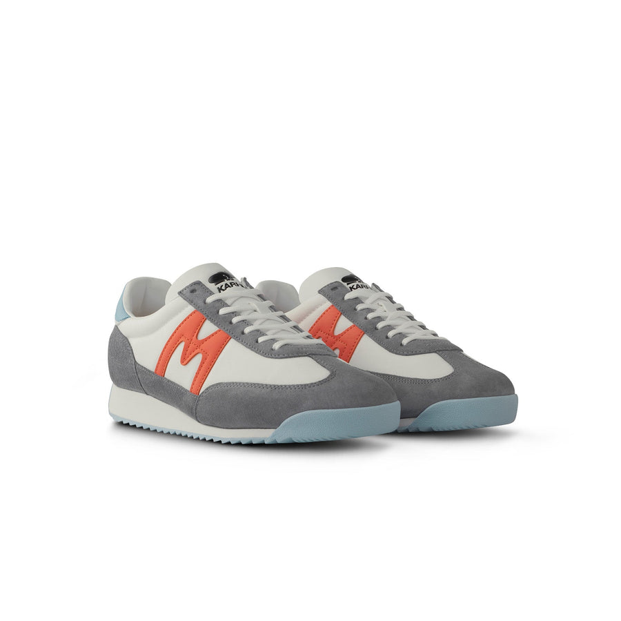 grey karhu men's mestari sneaker with red M logo and blue details
