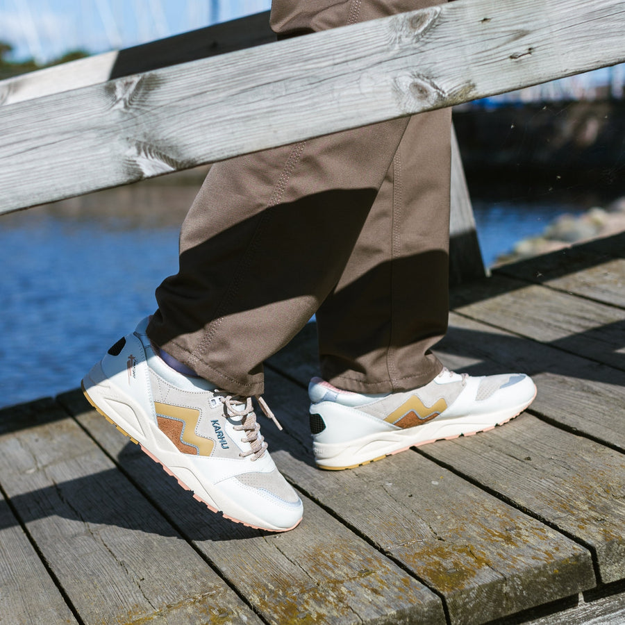 off white karhu women's comfort shoe with gold and orange detail