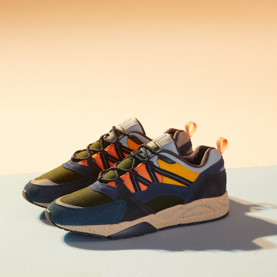 blue karhu men's shoe with green orange and yellow details