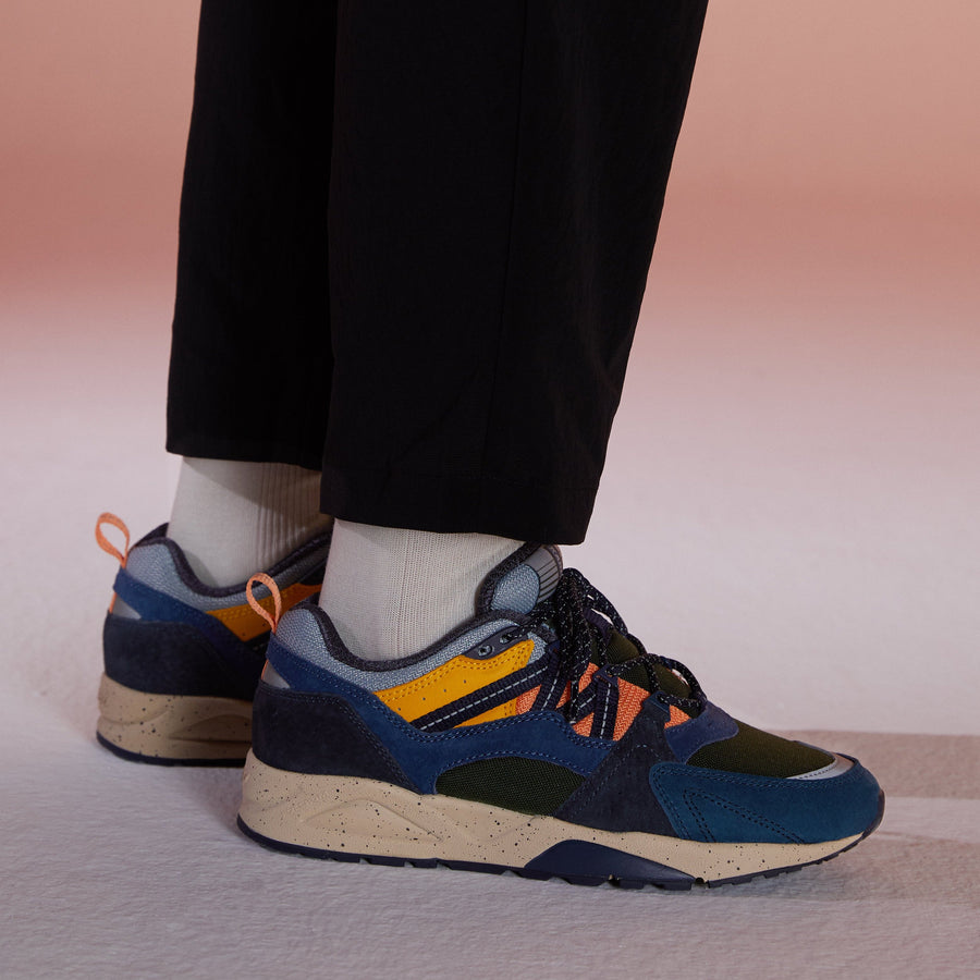 blue karhu men's shoe with green orange and yellow details