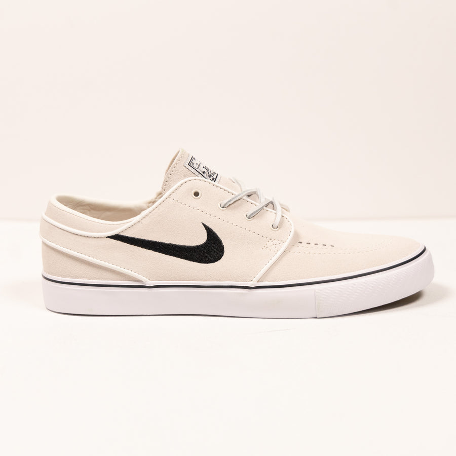 white nike sb stefan janoski men's skate shoe with black swoosh and white sole