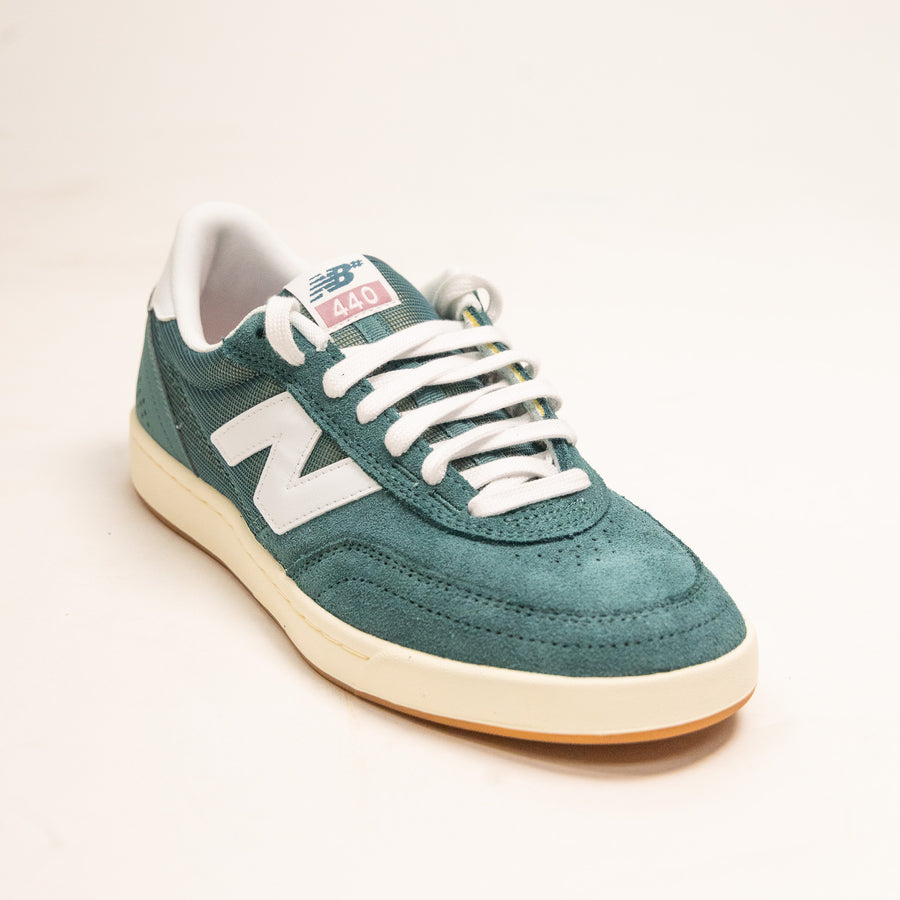 green men's new balance shoe with white sole