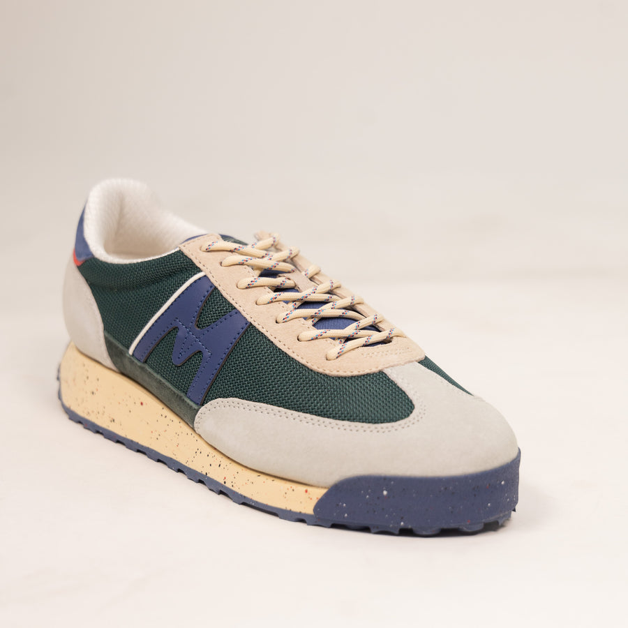 grey and green karhu men's shoe with speckled off white sole and blue details
