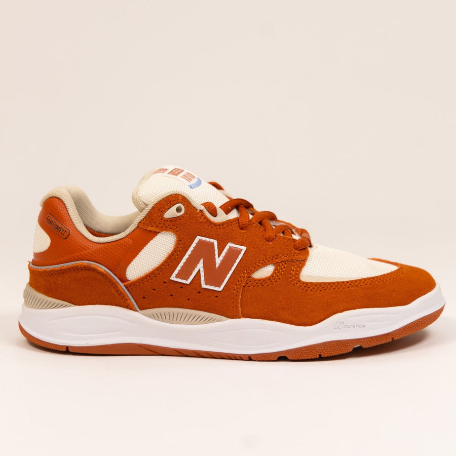 orange and white men's new balance skate shoe with white sole
