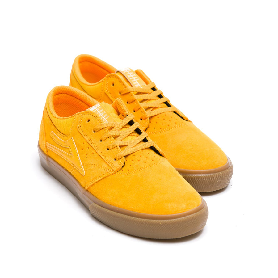 Yellow lakai griffin sneaker with a brown sole on a white background