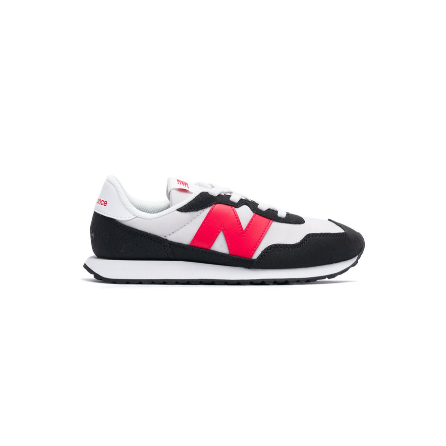 Black and white new balance 237 kids and toddler sneaker with red accents on a white background