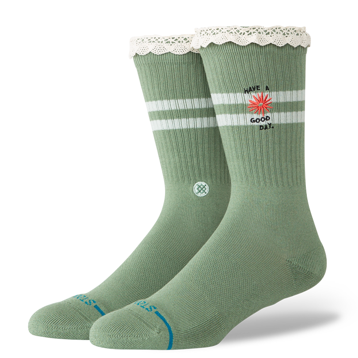 Green stance have a good day socks with white stripes and text on a white background