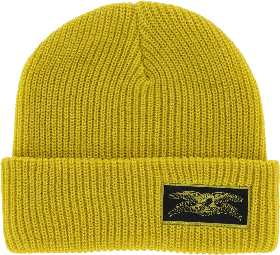 Yellow knit beanie with a logo patch on a white background
