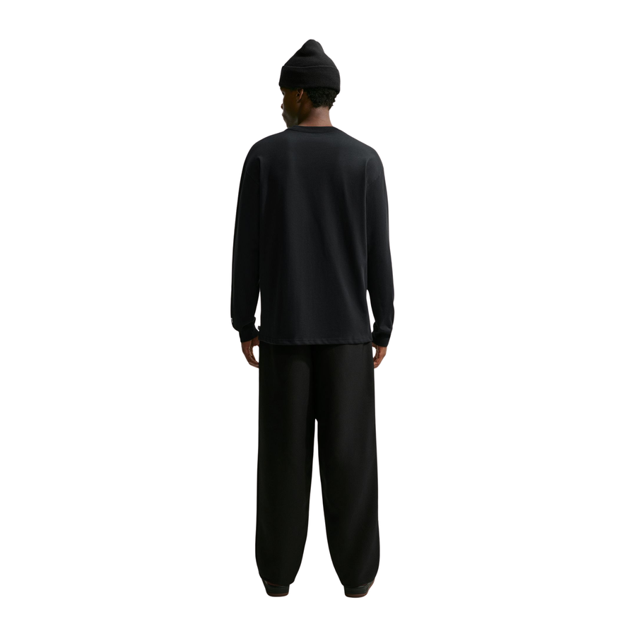 a man wearing a long sleeve Nike SB Yuto Horigome Air Force 1 Skate Tee in Black and a black nike sb beanie on a white background