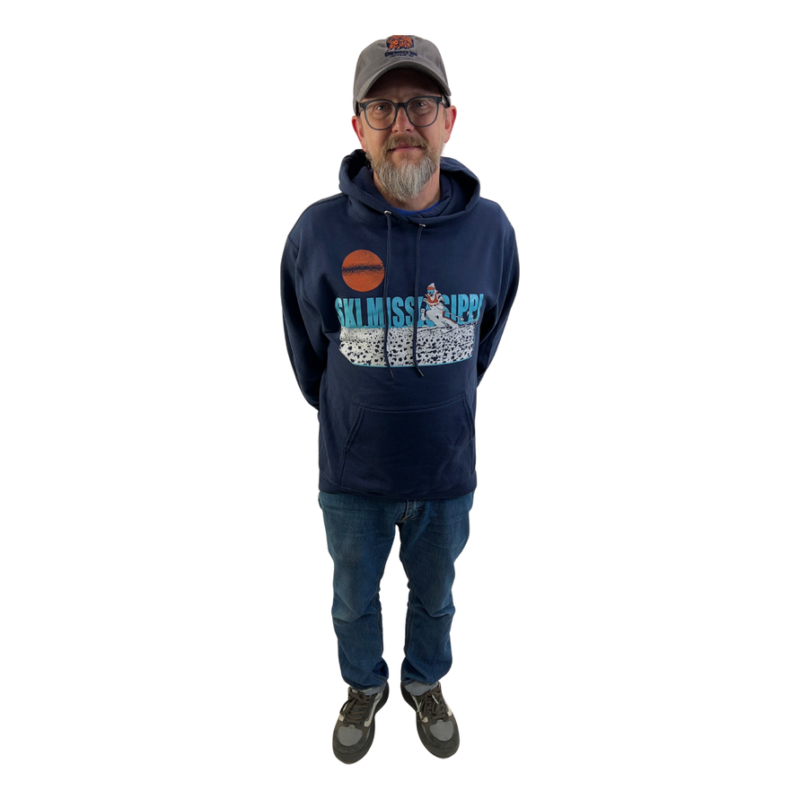 Man wearing a navy blue ski mississippi hoodie with graphics and text, standing against a white background