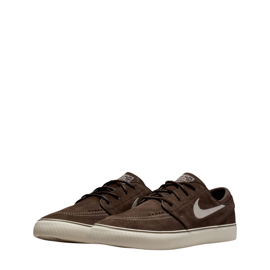 Brown nike sb janoski skateboard sneaker with a white swoosh logo on a white background