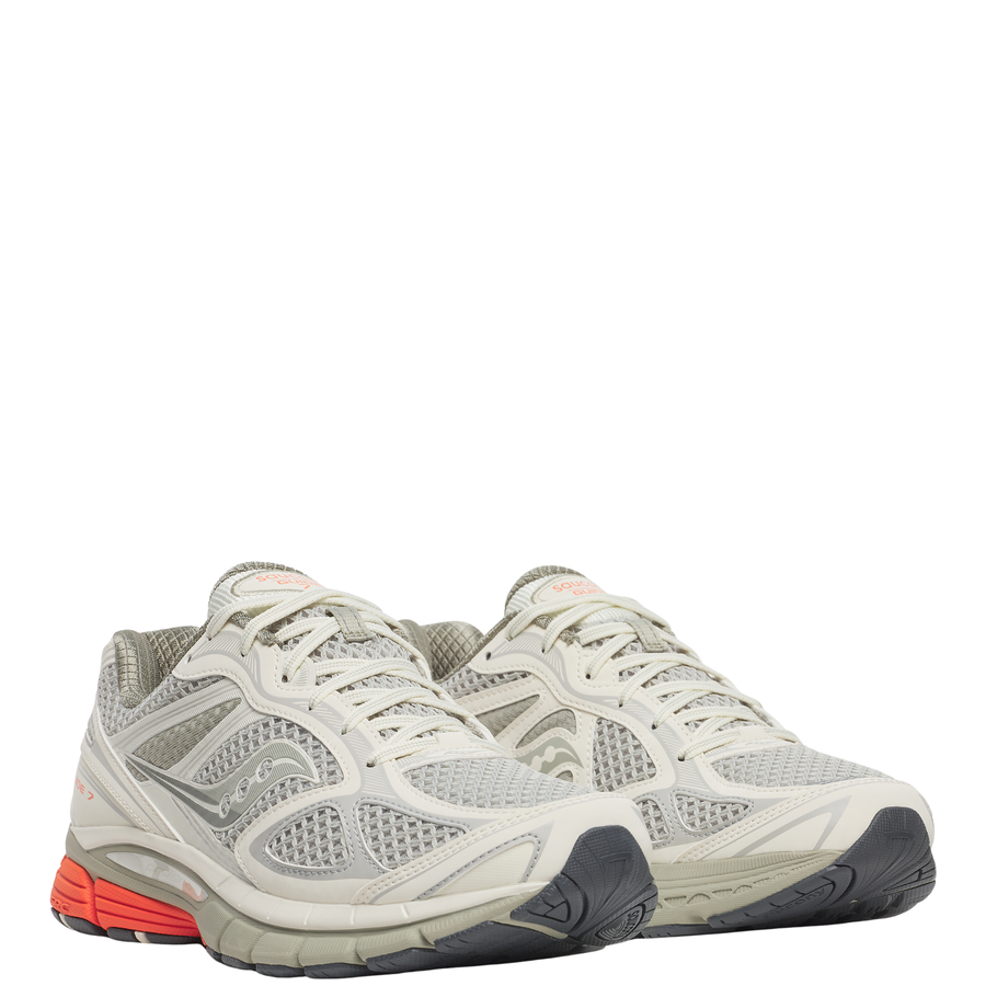 Gray tan saucony progrid guide 7 running shoe with orange sole on a white background
