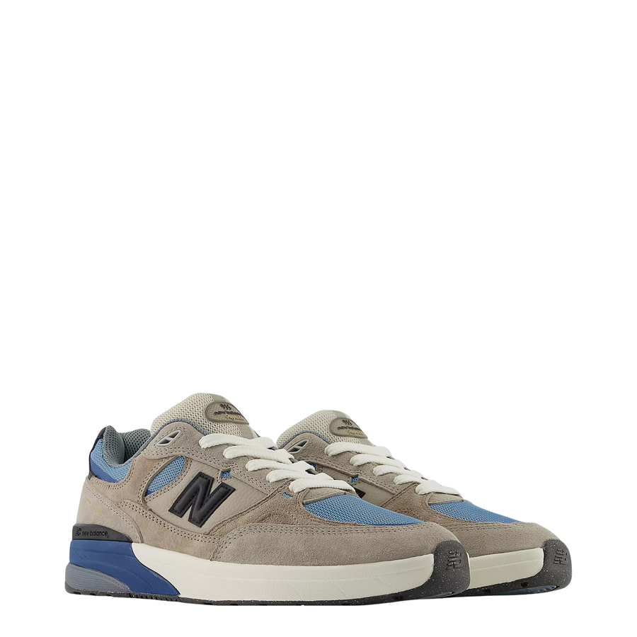 Beige and blue andrew reynolds 933 skateboard sneaker with New Balance logo on a white background