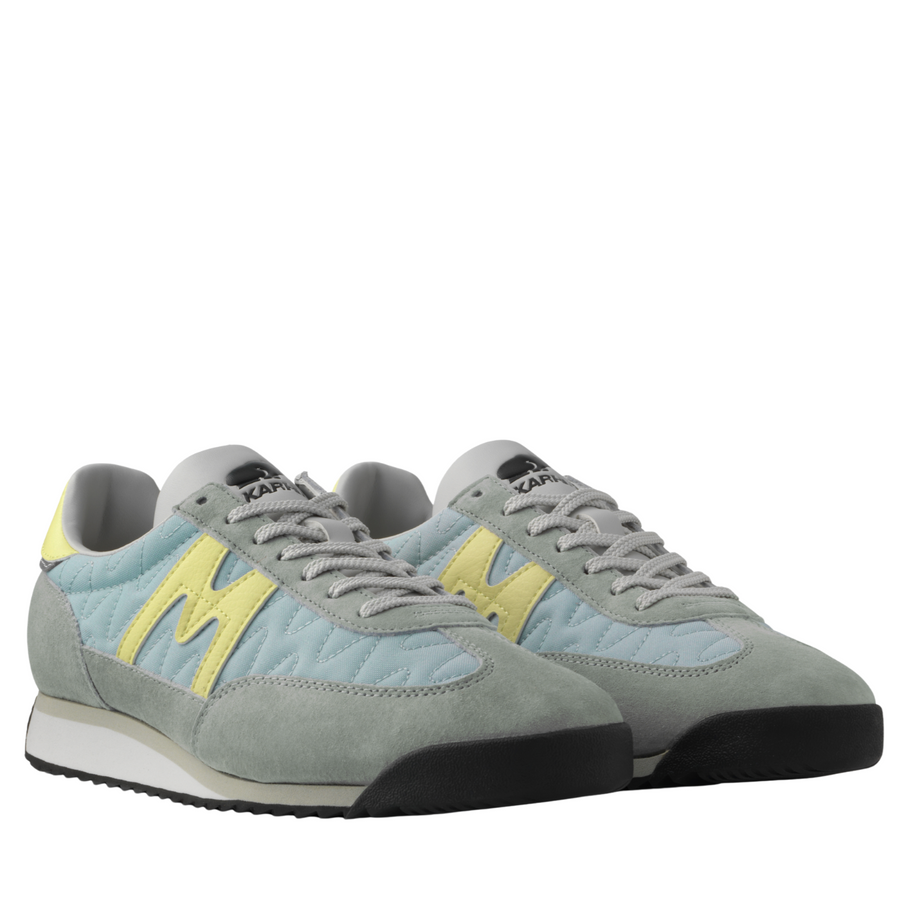 grey and blue karhu mestari Sneaker with a yellow 'M' logo on a white background