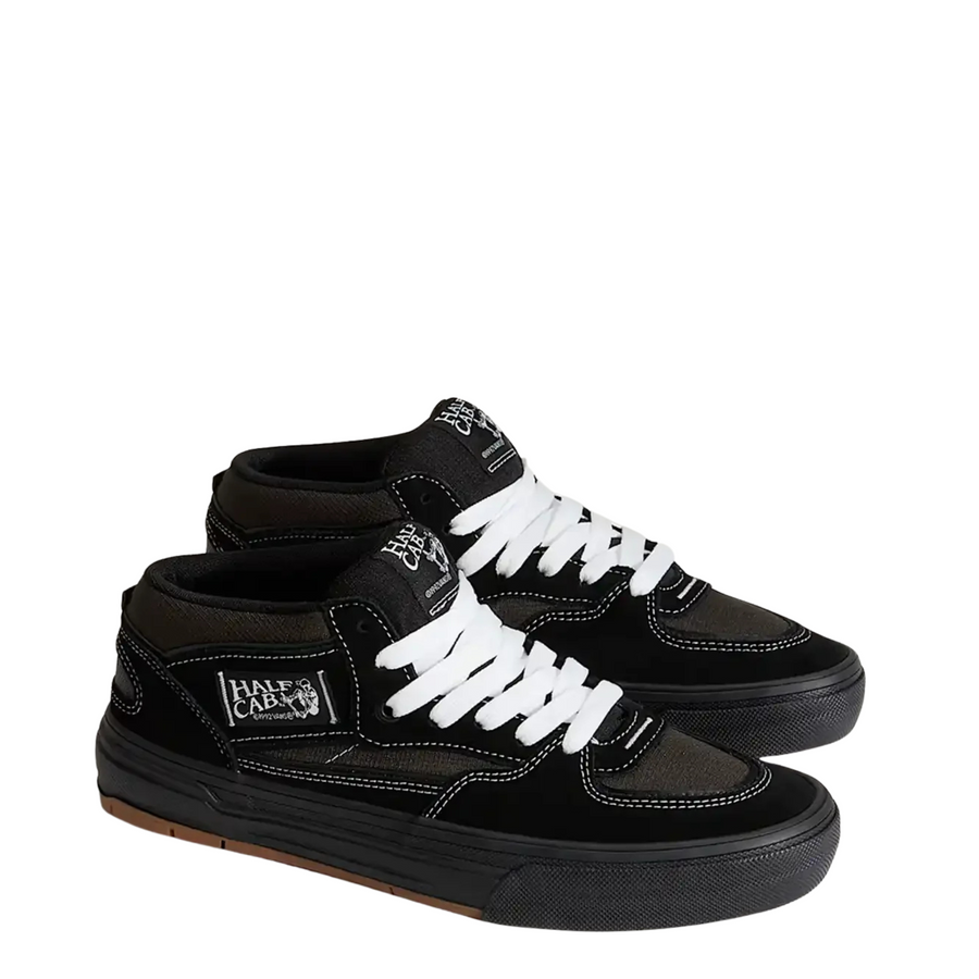 Black vans united by skateboarding half cab mid-top sneaker with white laces on a white background