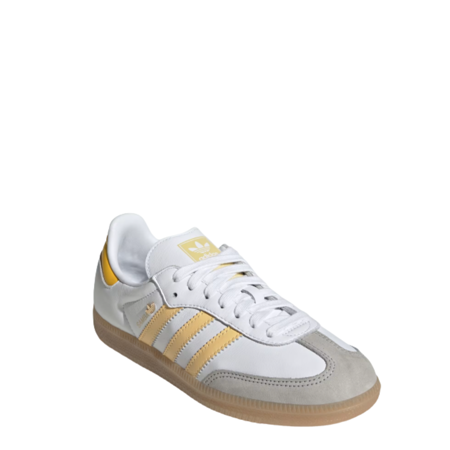 White Adidas samba sneaker with yellow stripes and a gum sole on a white background