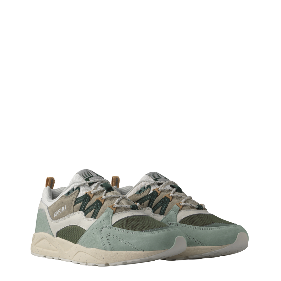 Karhu fusion 2.0 sneakers in a muted sage green, beige, and dark gray colorway, shown from a three-quarters angle against a plain white background.