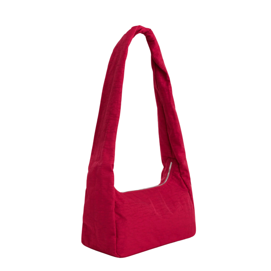 A bright red fabric baggu merigue shoulder bag with a single long strap, shown against a plain white background.