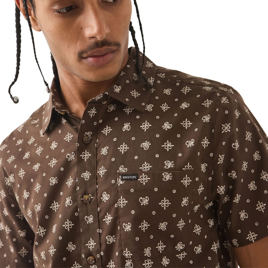 brown brixton men's charter print short sleeve woven button-up shirt with a bandana pattern on a man on a white background