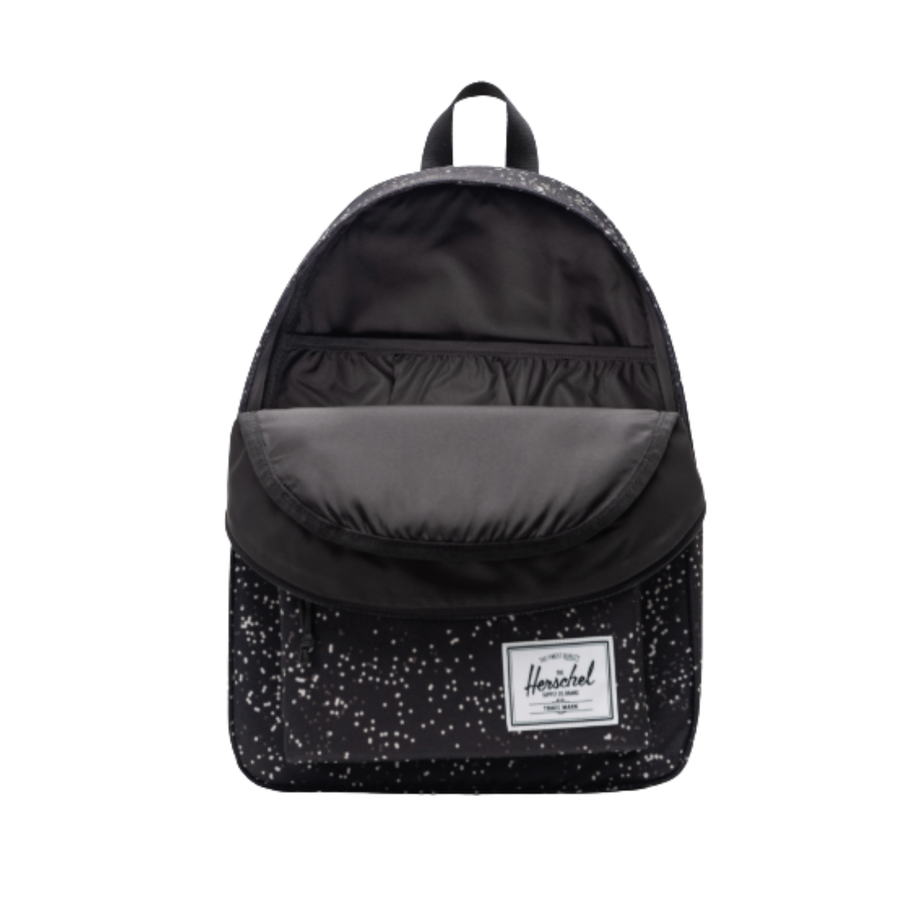 black herschel classic backpack with white blurred dots on a white background