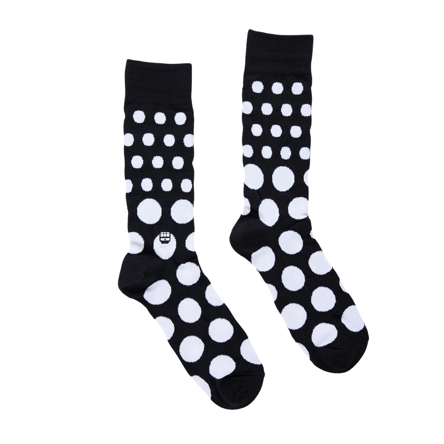 Black bonfolk socks with white polka dots on a white background