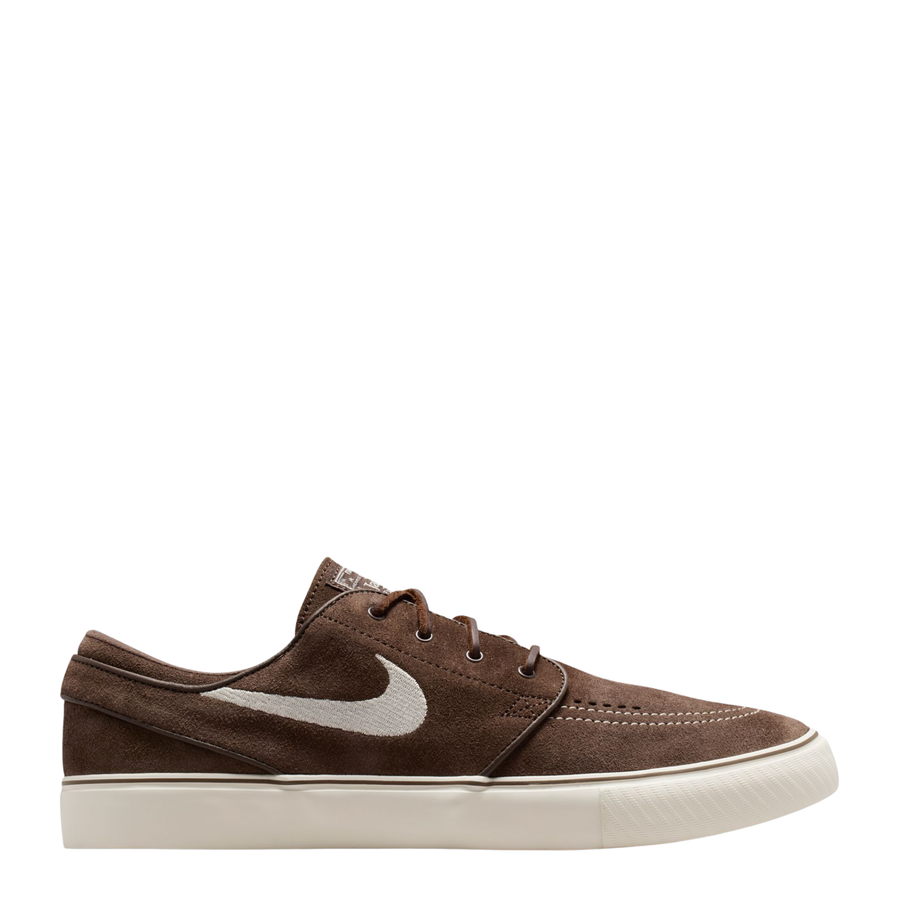 Brown nike sb janoski skateboard sneaker with a white swoosh logo on a white background