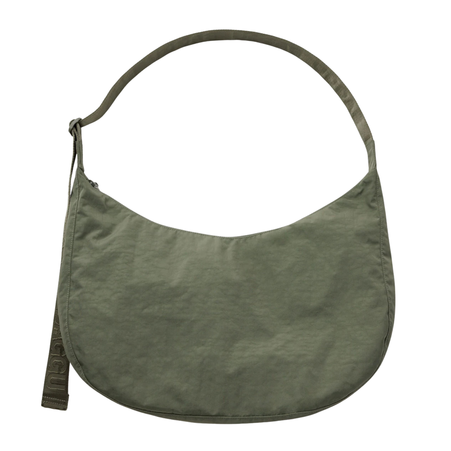 An olive green baggu crescent-shaped shoulder bag with a single strap and a small hanging tag, shown against a plain white background.