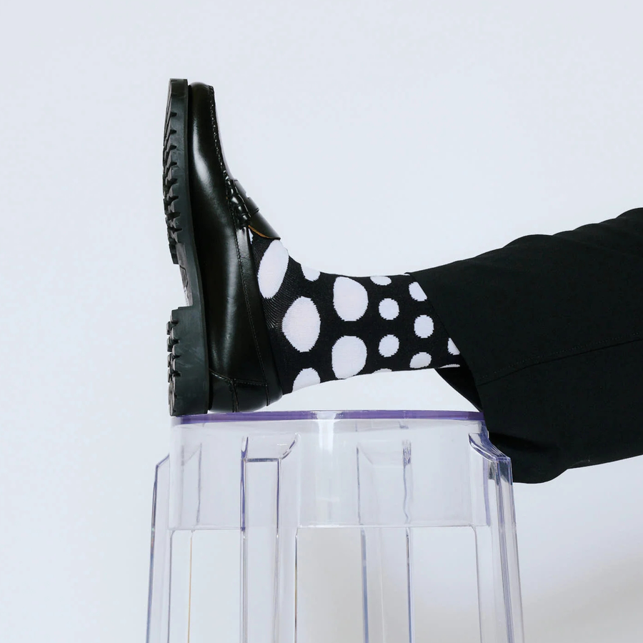 Black bonfolk socks with white polka dots on a white background
