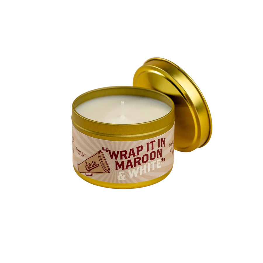 scent library by laurel merchantile Candle with wrap it in maroon and white label on a white background