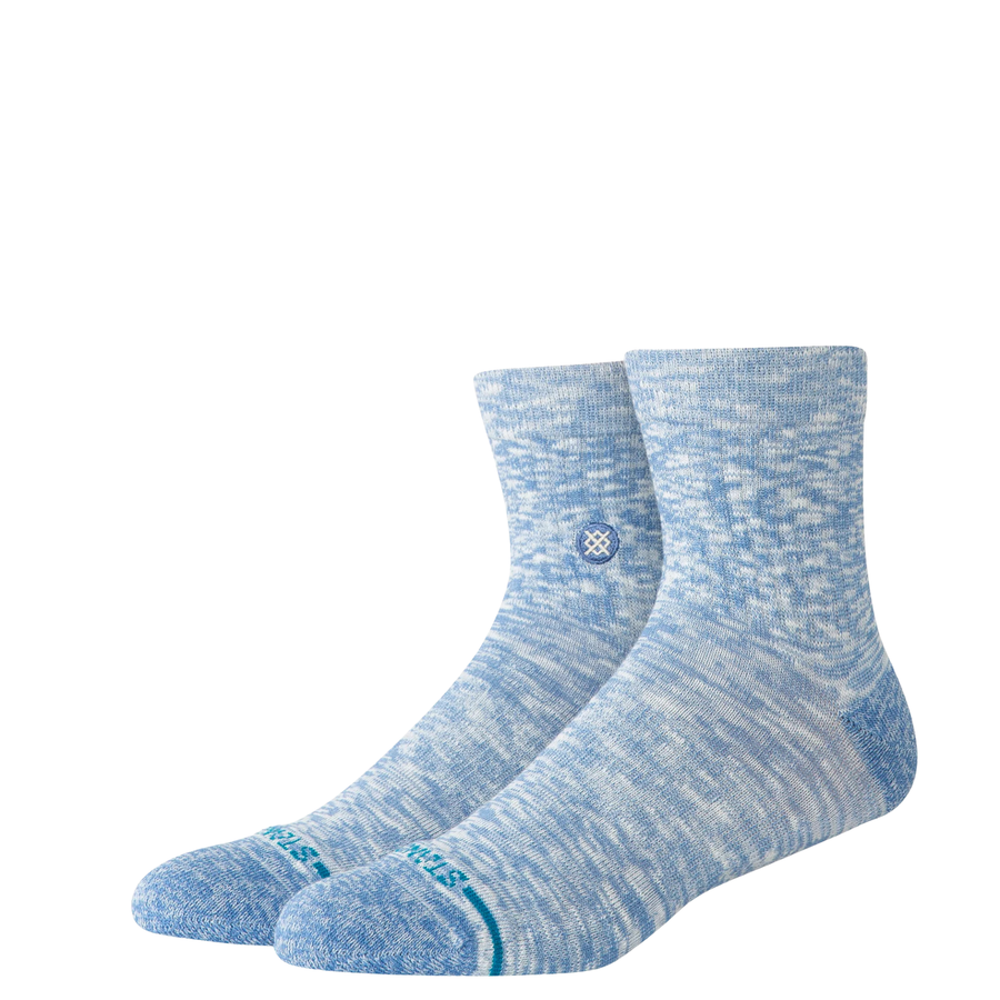 Pair of blue stance slub quarter socks with a subtle pattern on a white background