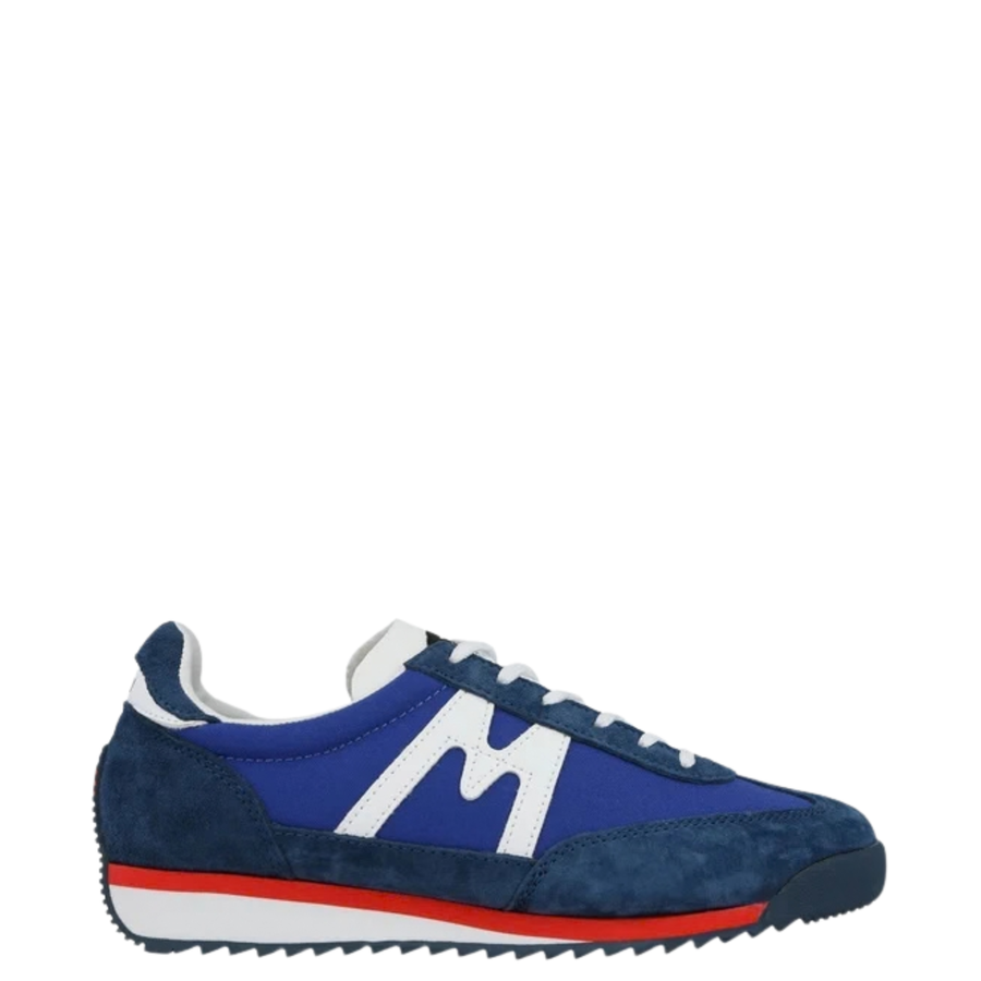Blue karhu mestari 76 sneaker with red and white sole on a white background