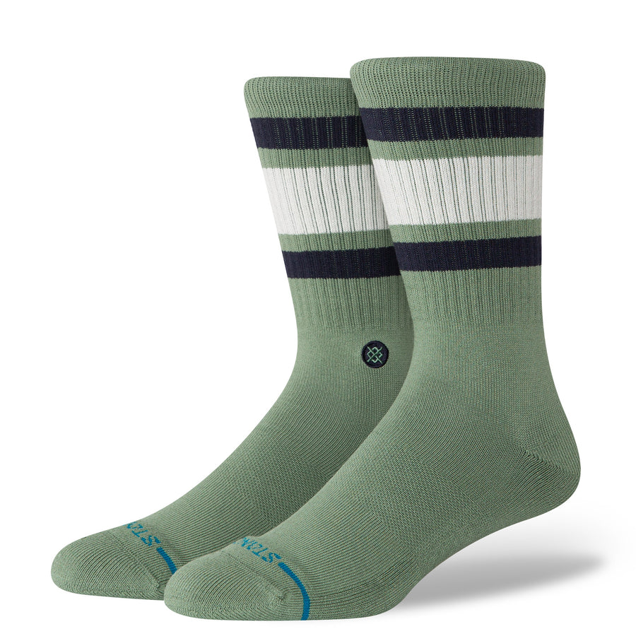 Pair of green stance men's boyd st crew socks with black and white stripes on a white background