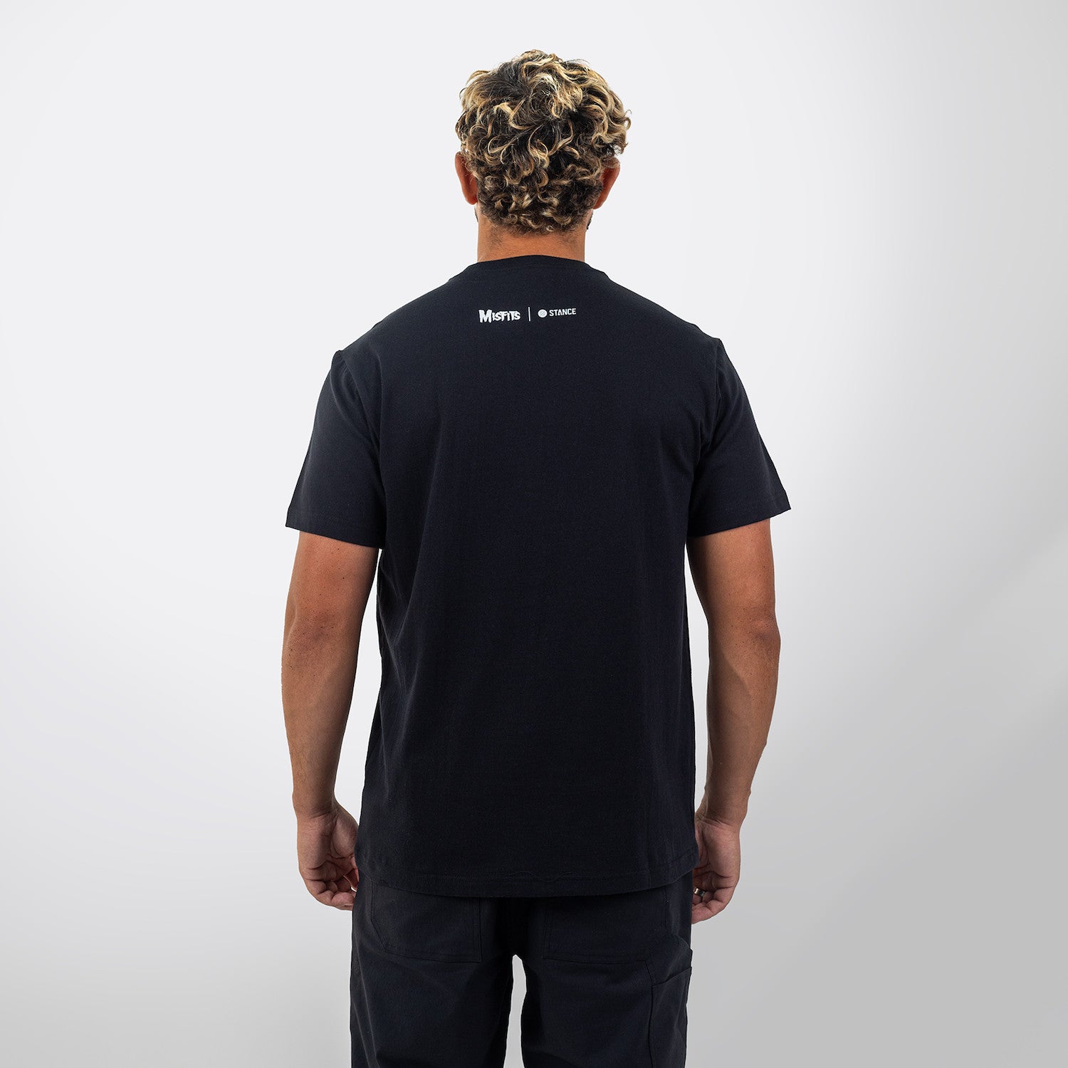 Black Stance t-shirt with 'Misfits' graphic design featuring a skeleton and crossbones on a white background
