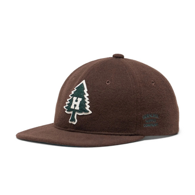 brown herschel supply co vintage ranger hat with green tree on a white background with white H in the center