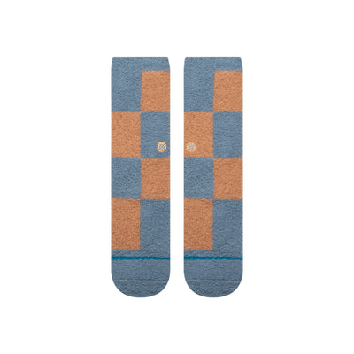 Pair of checkered stance patchwork cozy socks with blue and orange squares on a white background