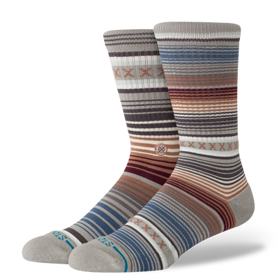 Two striped stance curren st crew socks with a pattern on a white background