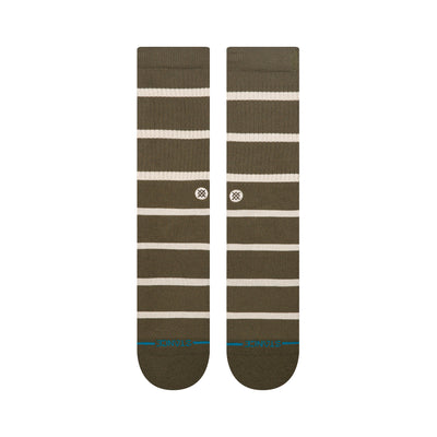 Pair of green stance butter blend crew socks with white stripes on a white background