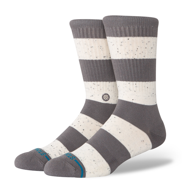 Pair of gray and white stance nep striped socks on a white background