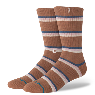 Pair of brown striped stance butter blend socks with a visible brand logo on a white background