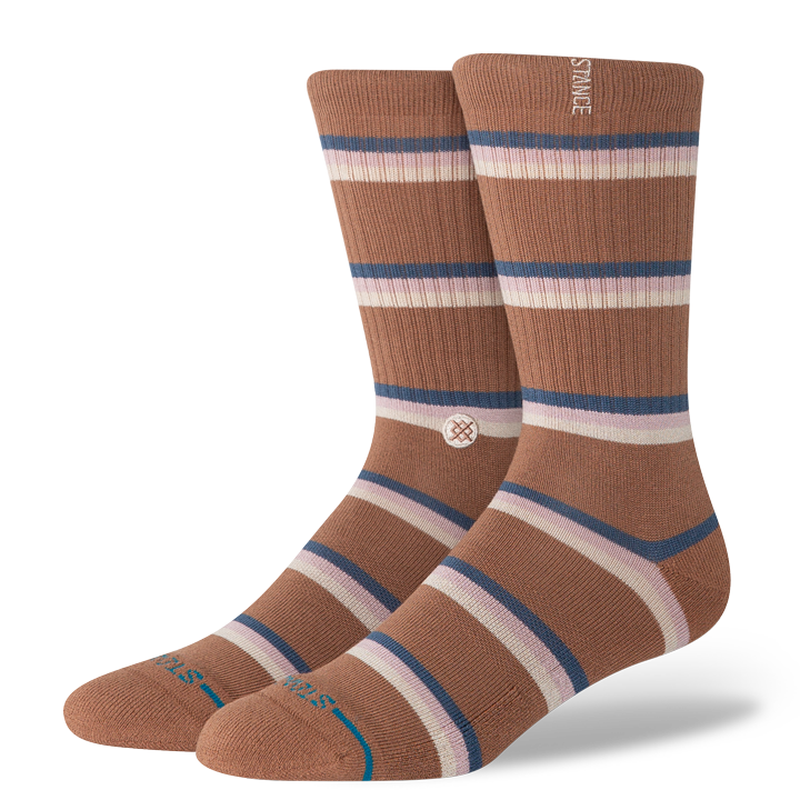 Pair of brown striped stance butter blend socks with a visible brand logo on a white background