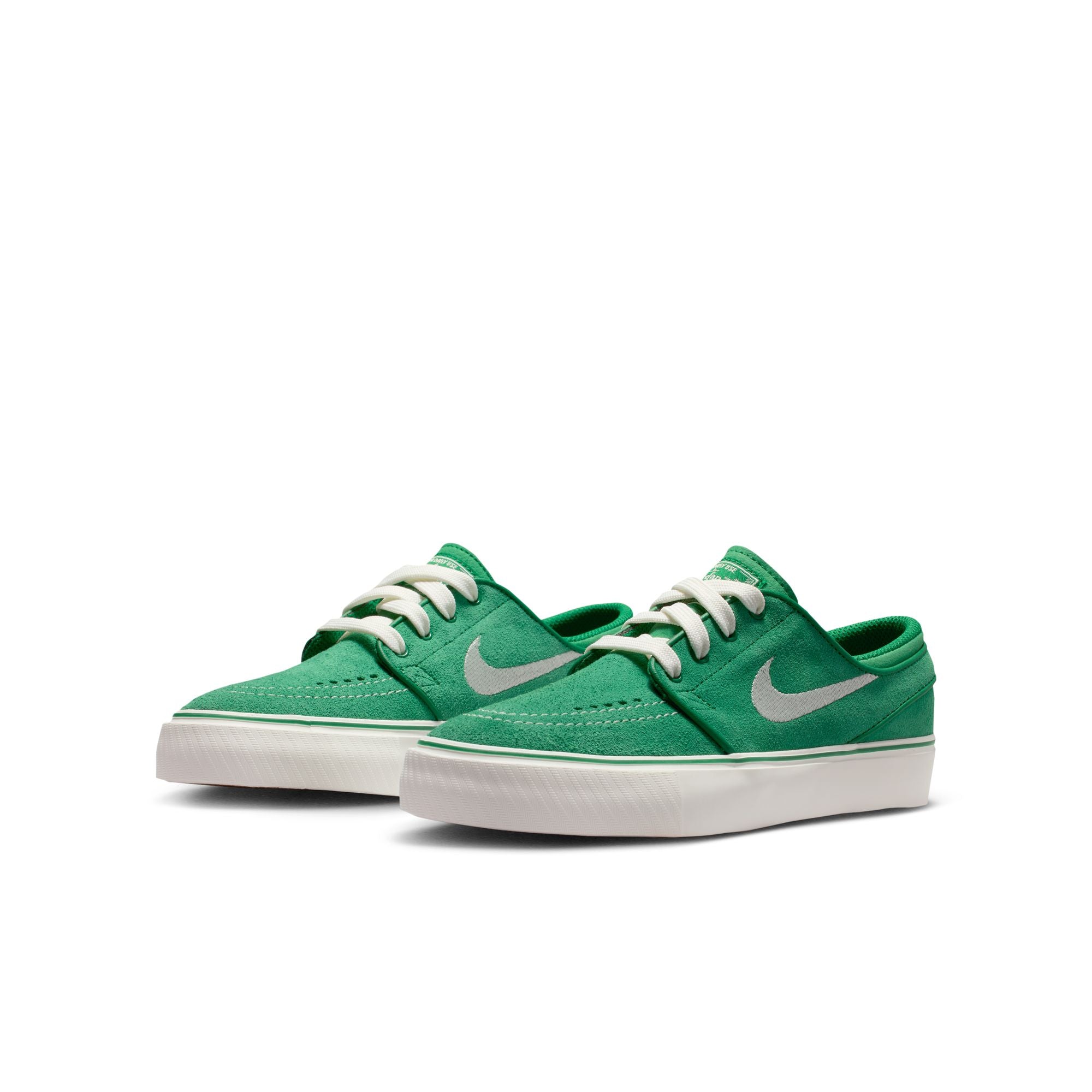 Green big kids janoski sneaker with white Nike logo on a white background