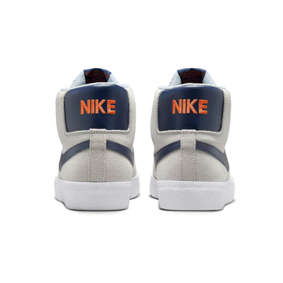 grey mid top nike sb blazer with blue nike swoosh and orange detail and white sole