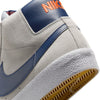 grey mid top nike sb blazer with blue nike swoosh and orange detail and white sole