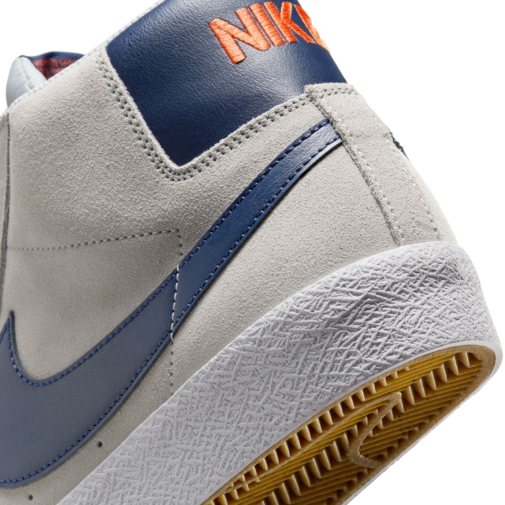 grey mid top nike sb blazer with blue nike swoosh and orange detail and white sole