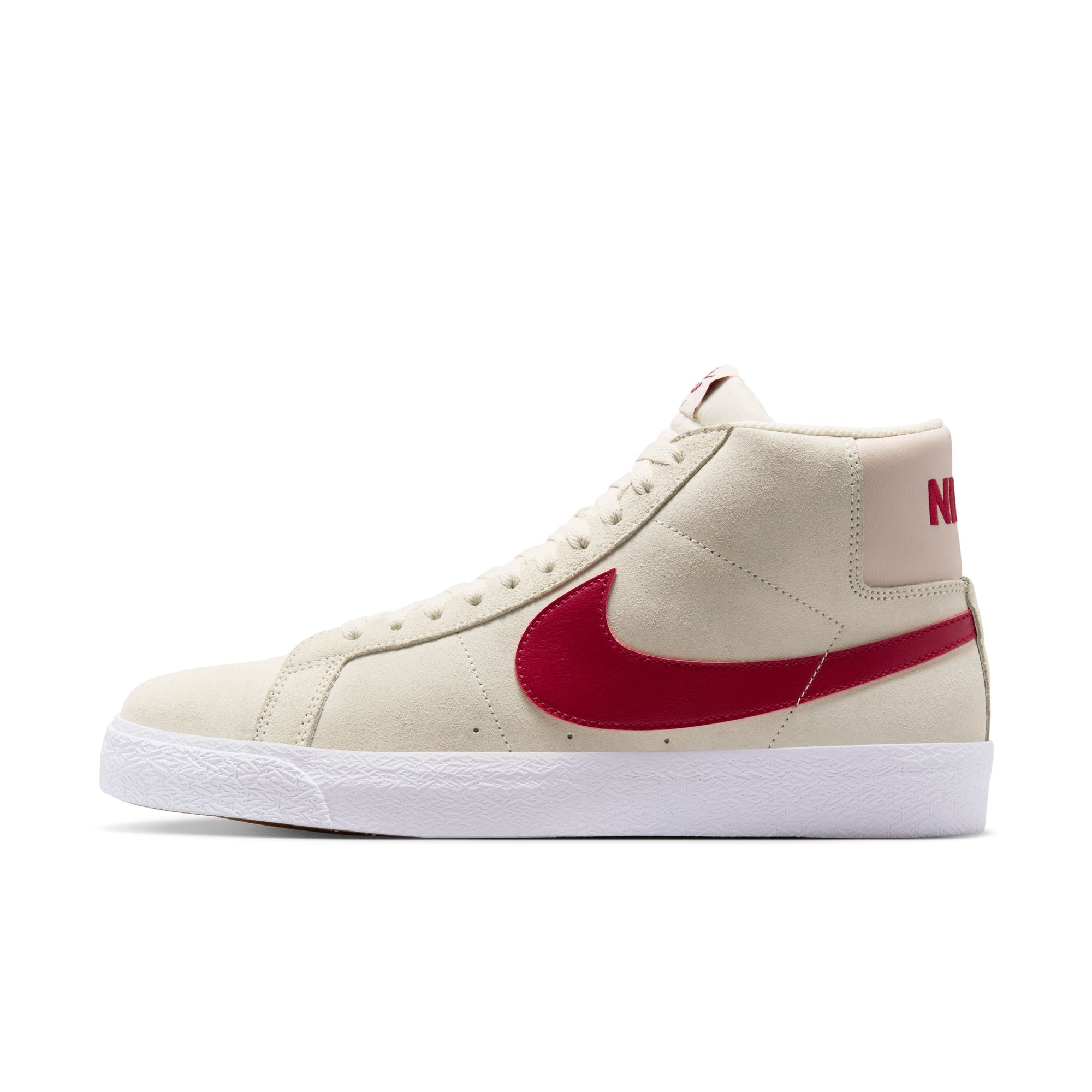 Beige nike sb blazer mid skateboard sneaker with red swoosh logo on a white background